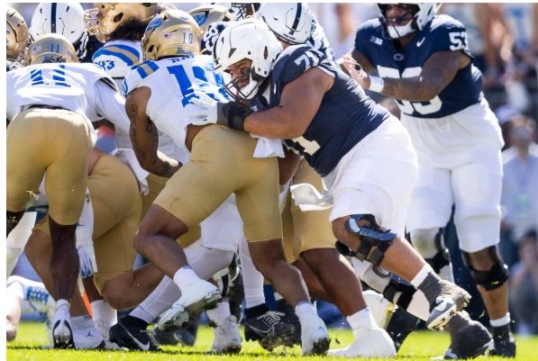 Football players collide during tackle