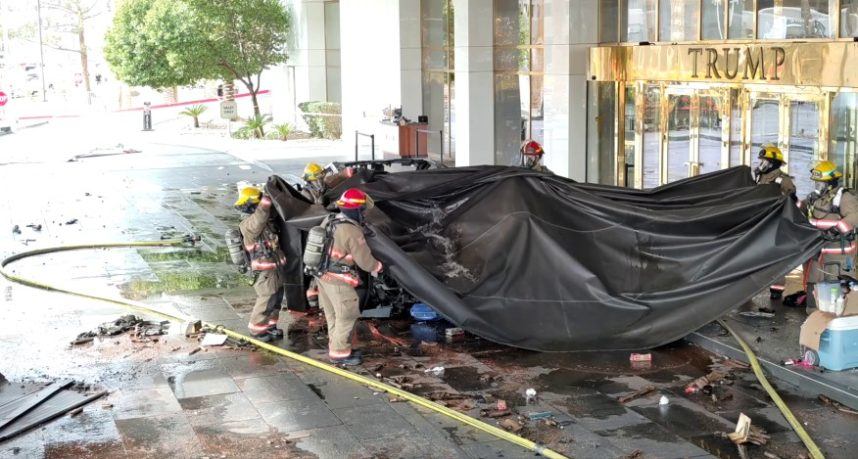 Firefighters extinguish burning car