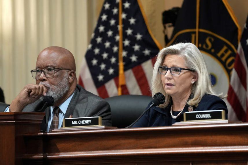 Two people talking at desk