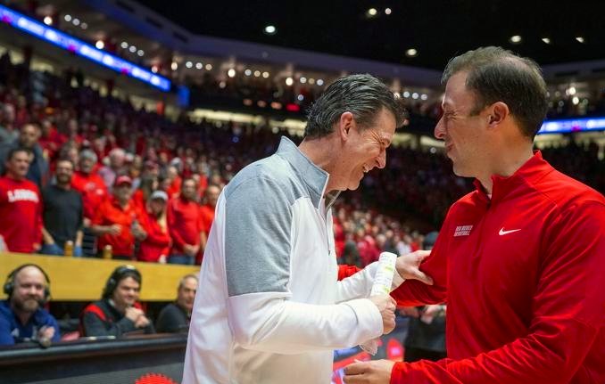 Two men wearing red uniforms