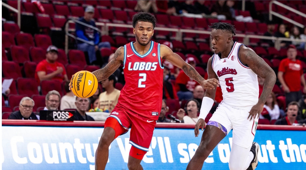 Two players leap for basketball