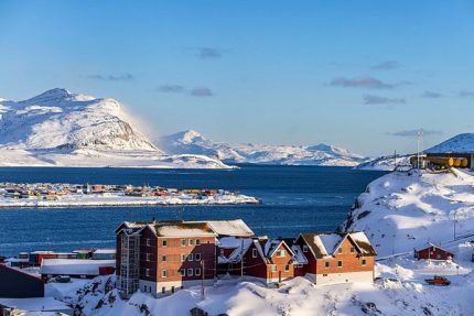 Greenland village in winter fjord