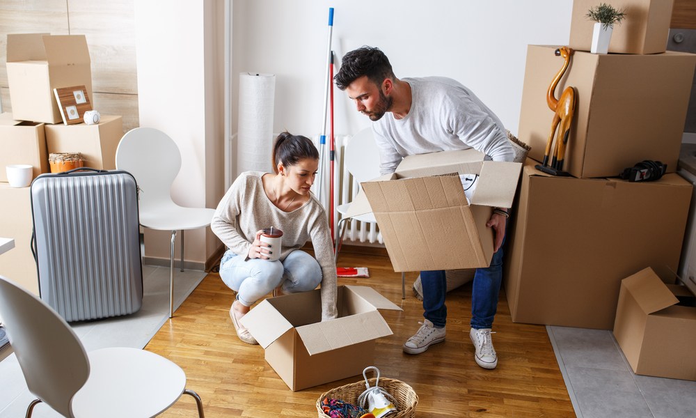 Couple packing boxes together