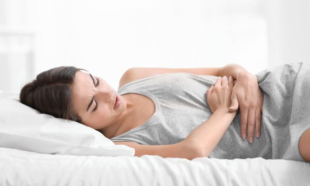 Woman clutching stomach in pain