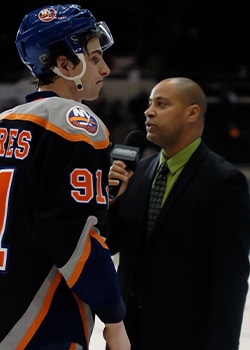 Two broadcasters at hockey game