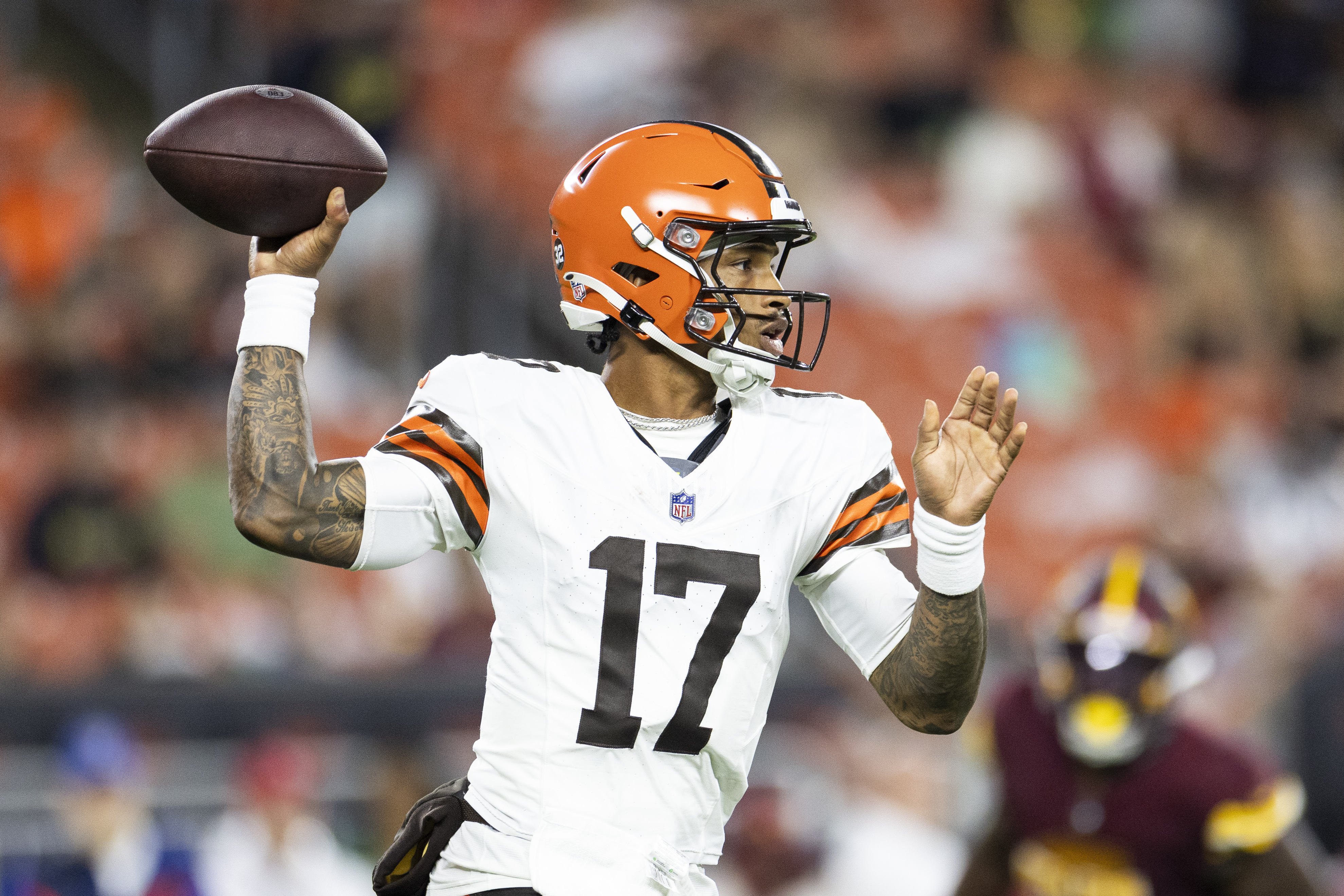 Quarterback throwing football during game