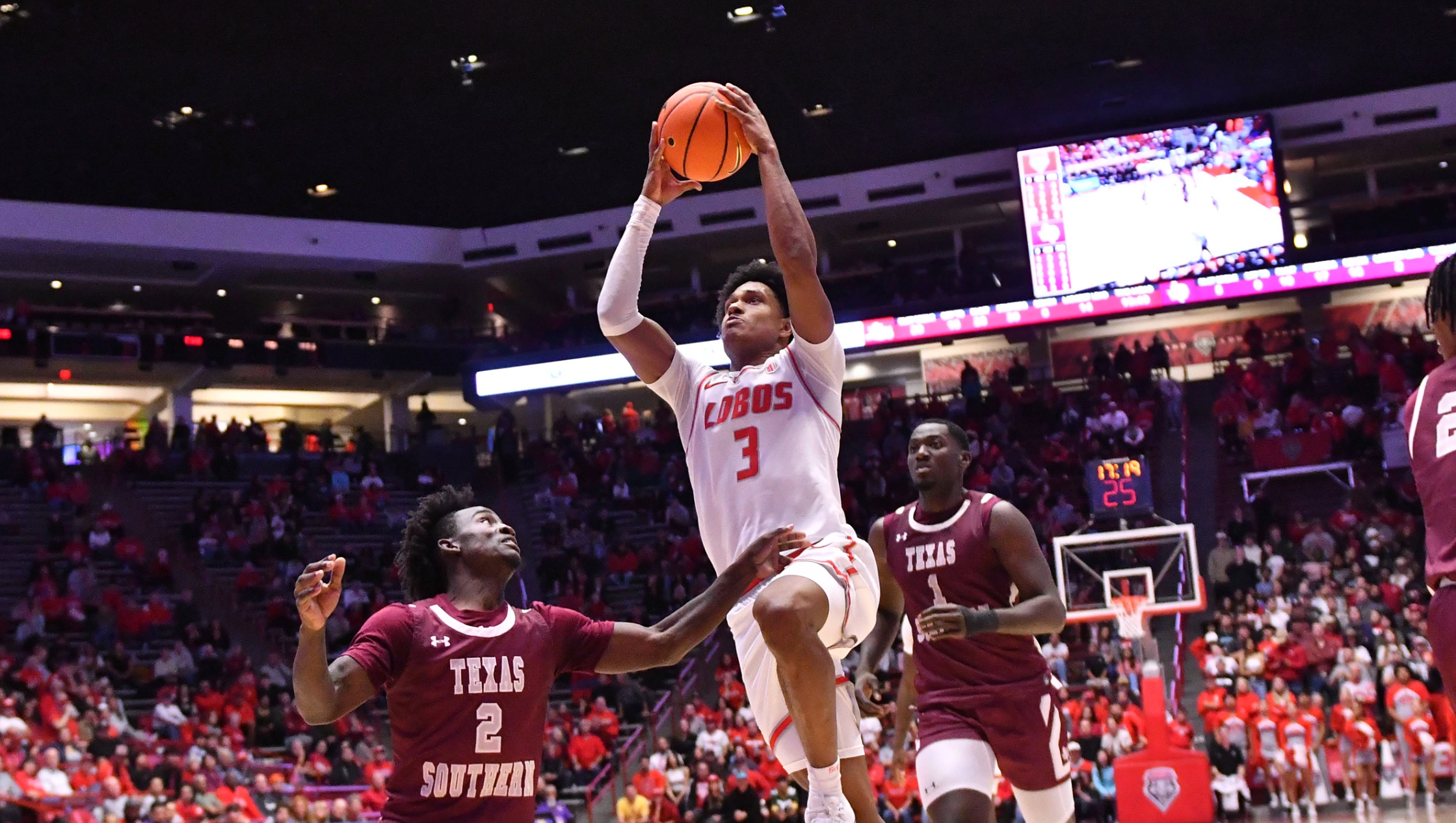 Basketball player leaps during game