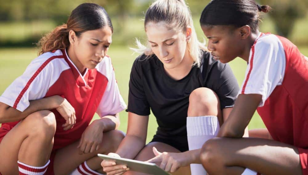 Women coaches reviewing tactics together