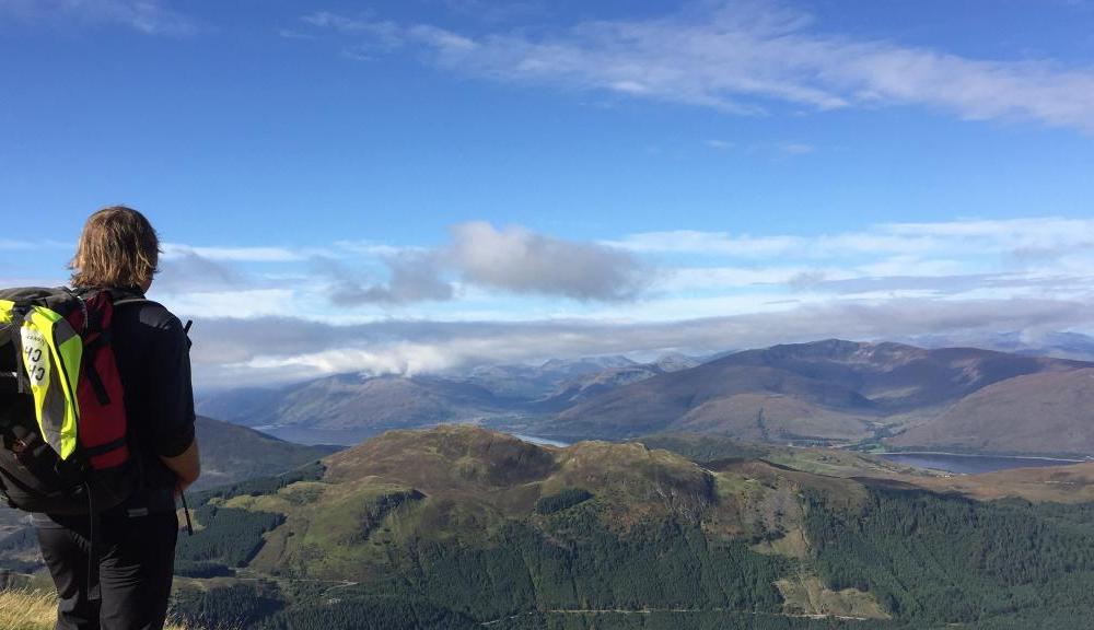 Hiker viewing Three Peaks mountains