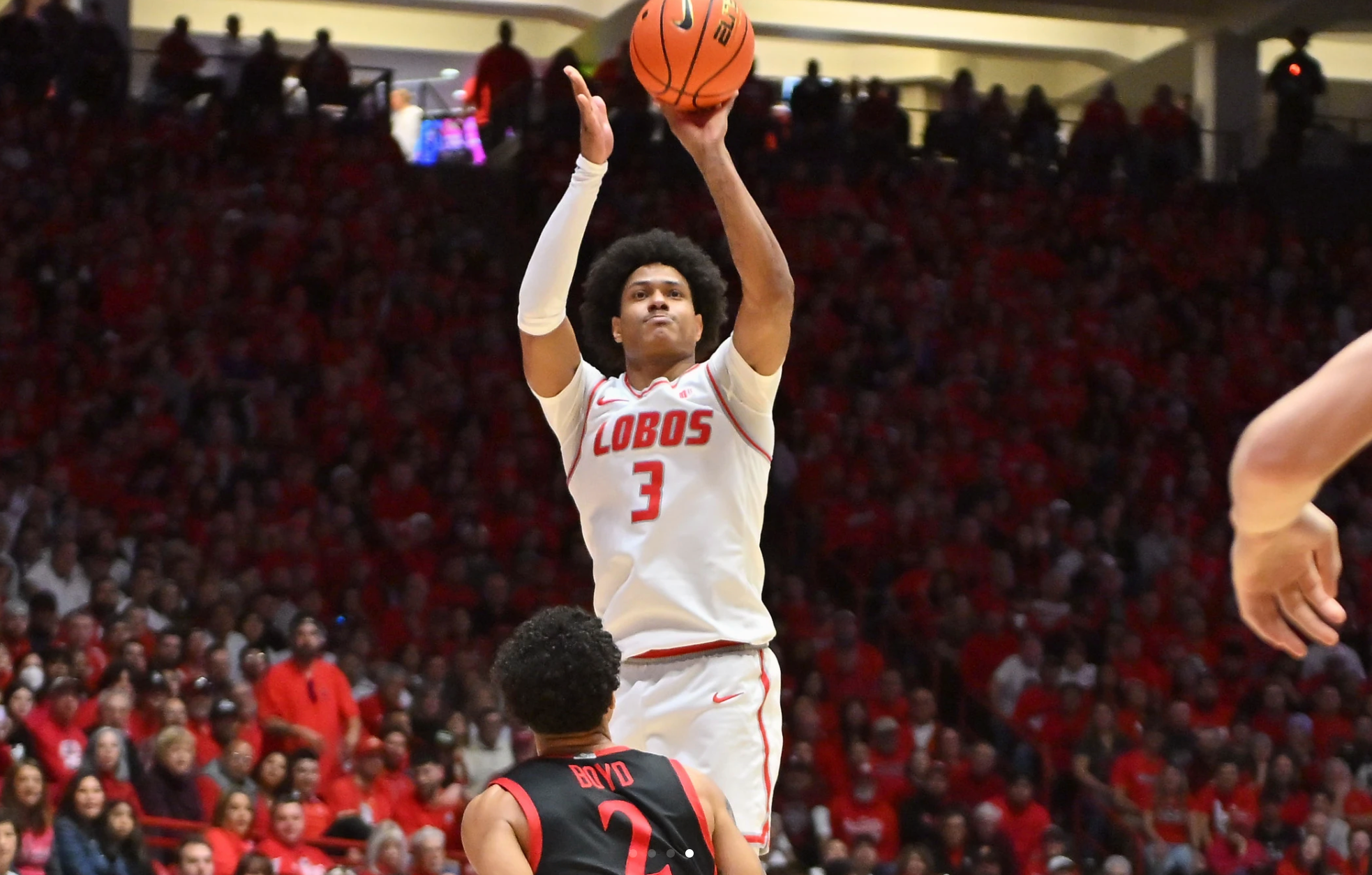 Basketball player takes jump shot