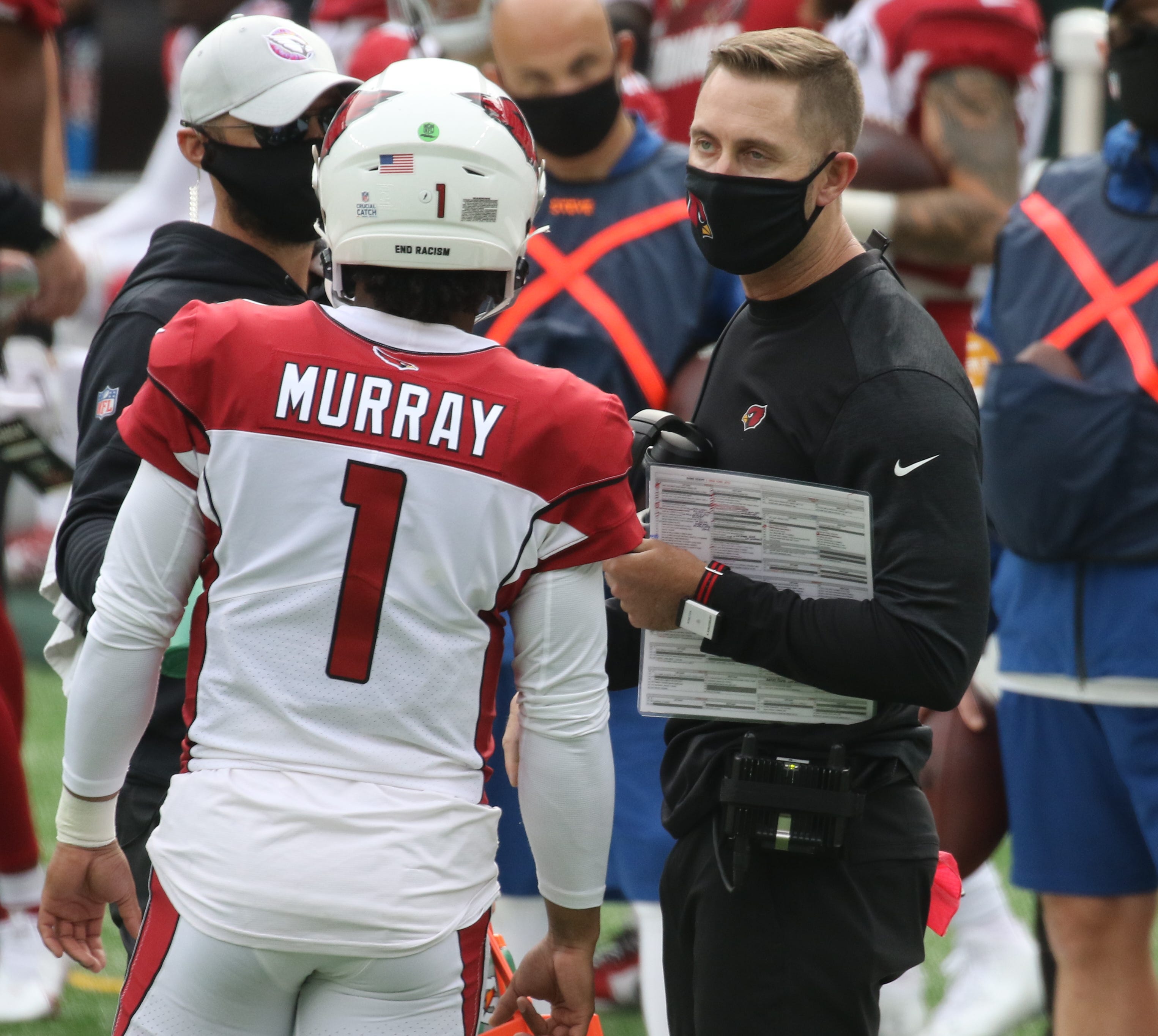 Coach instructs player on field