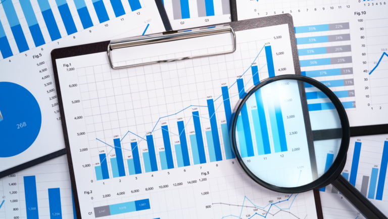 Magnifying glass analyzing dashboard data