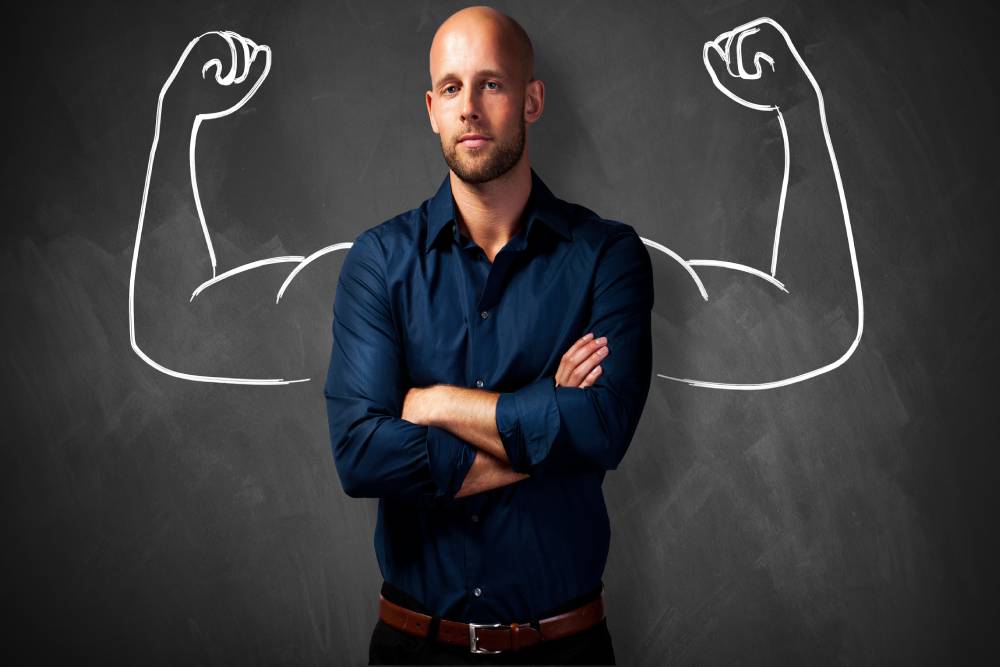 Man flexing in blue office shirt