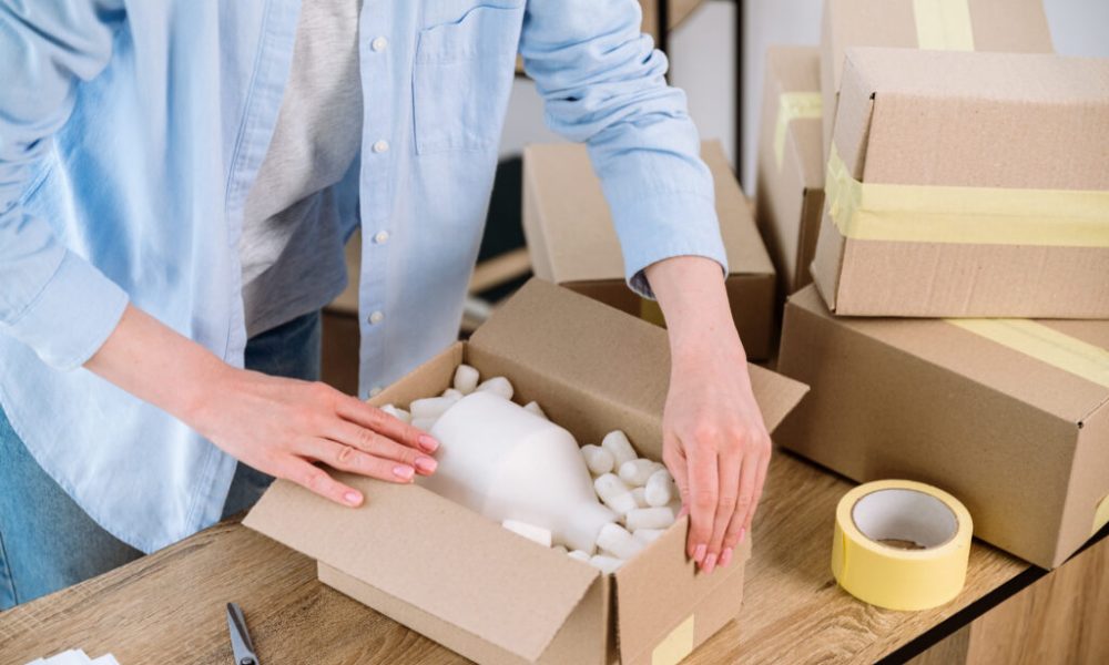 Person packing boxes for shipping