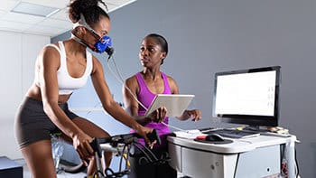 Physiologist guiding athlete during training