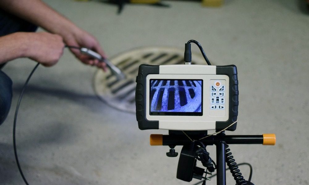 Technician operating sewer inspection camera