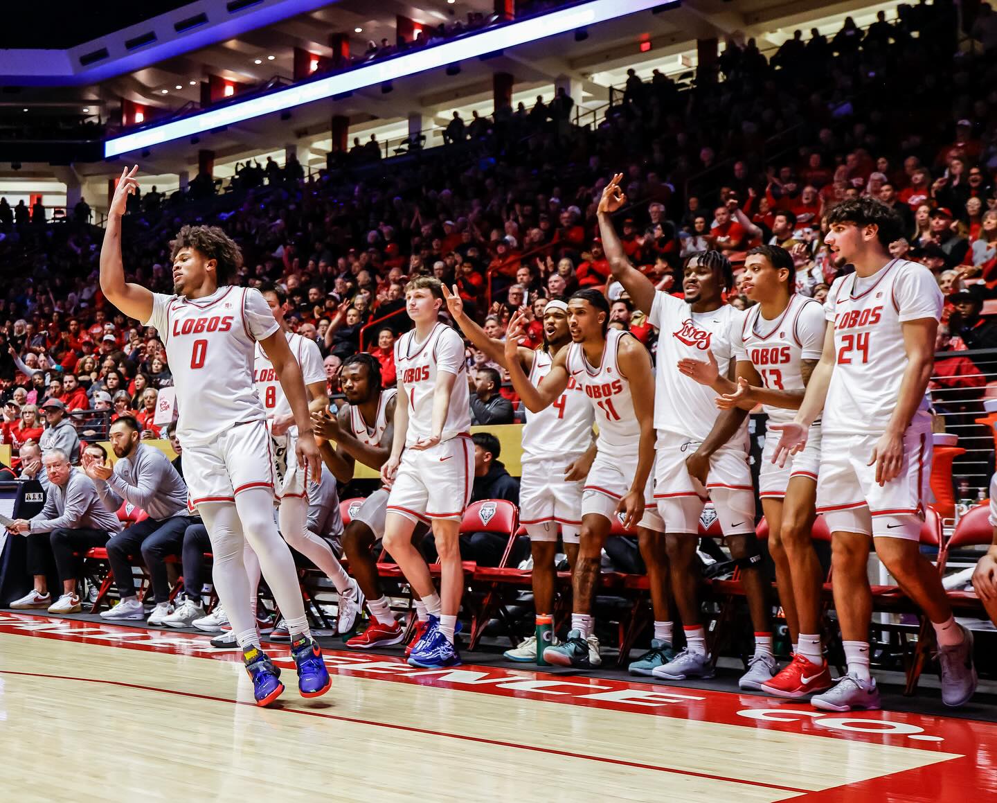 basketball team celebrates on bench