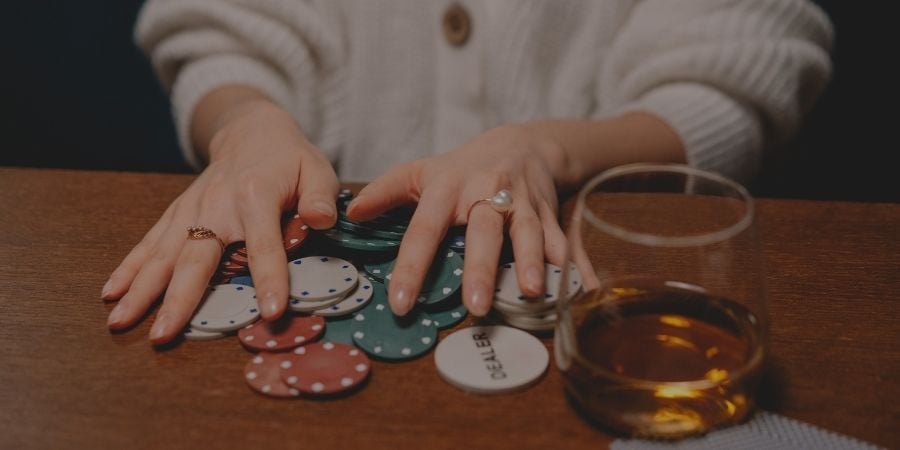 Woman plays poker at casino table