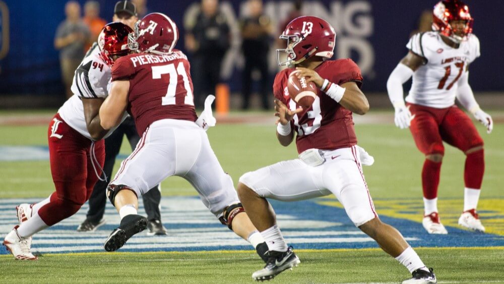 College football players battling on field