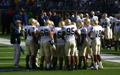 Notre Dame football team huddles together