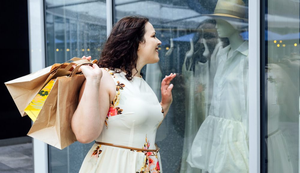 Woman shopping, viewing summer fashion display