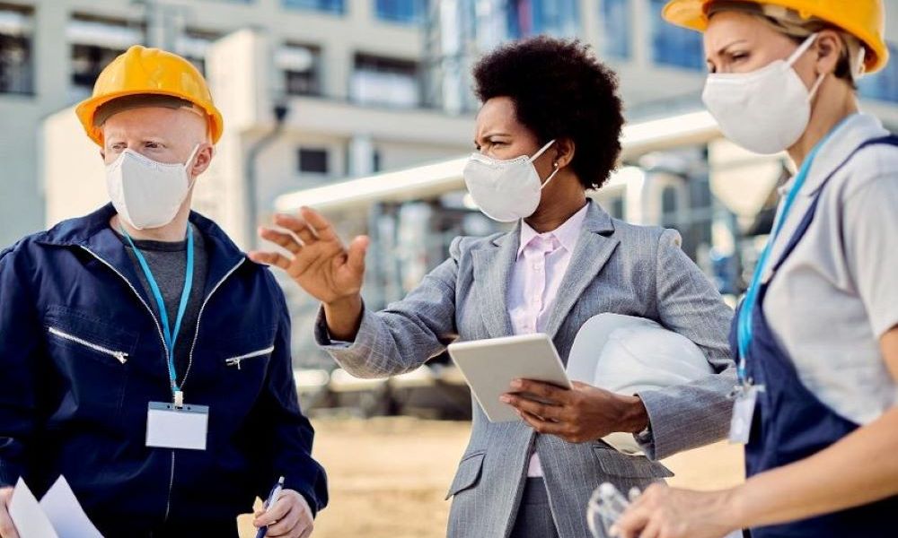 Workers wearing protective asbestos removal gear