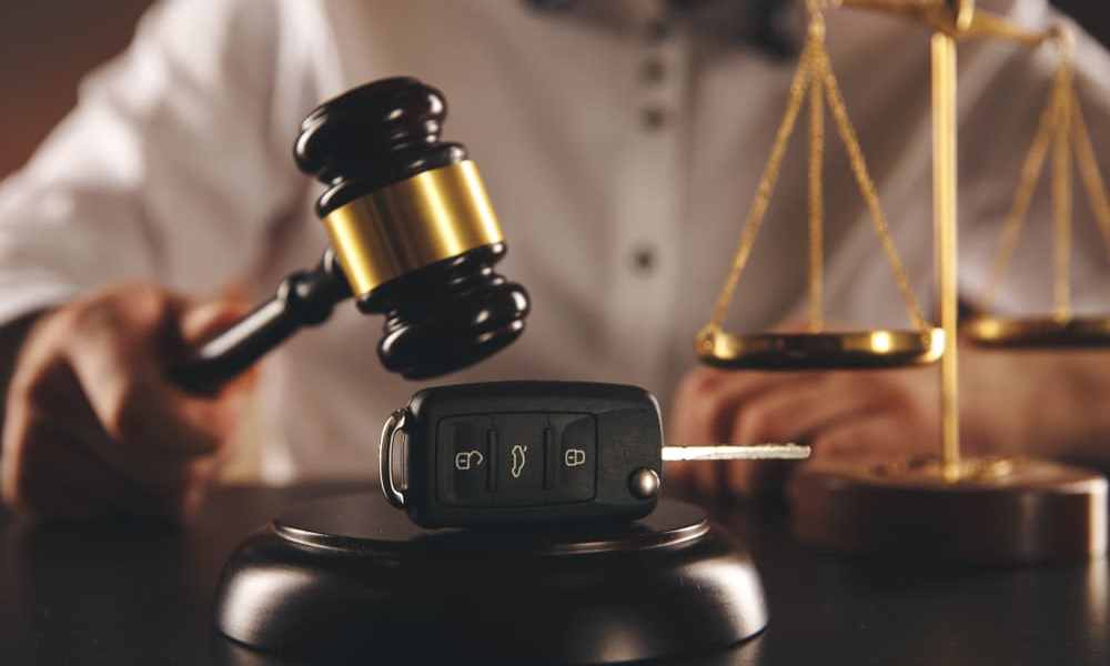 Gavel and keys on wooden desk