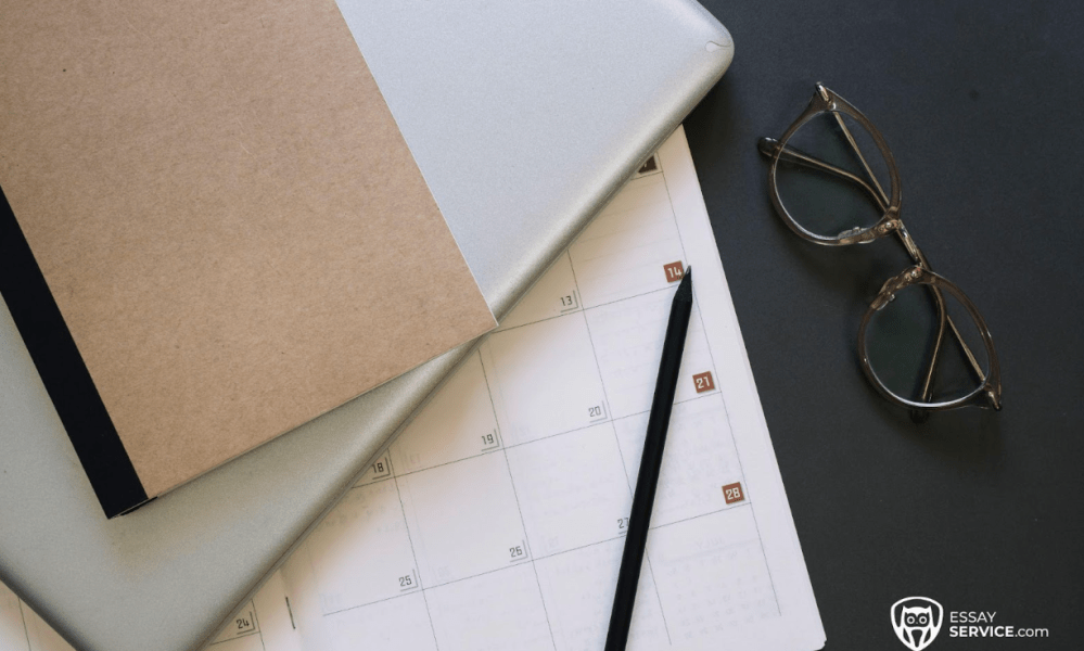 Calendar, notebook and glasses on desk