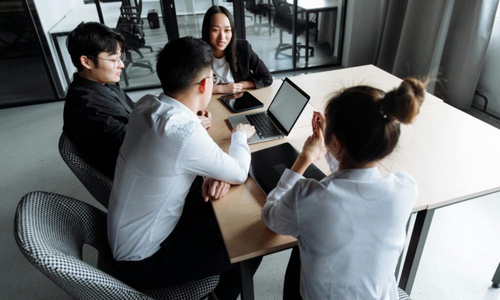 Four colleagues in office meeting