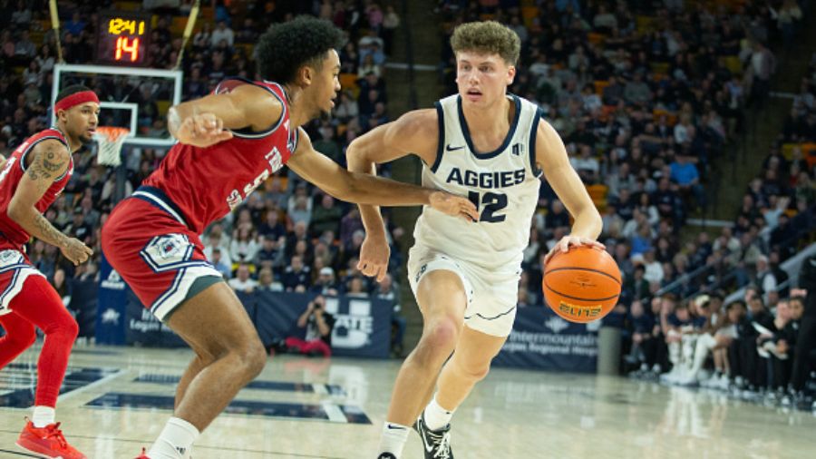 Basketball player dribbling past defender