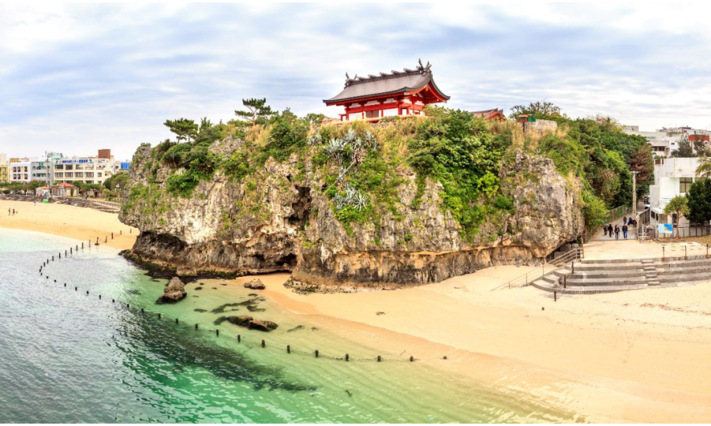 Red temple perched on coastal cliff