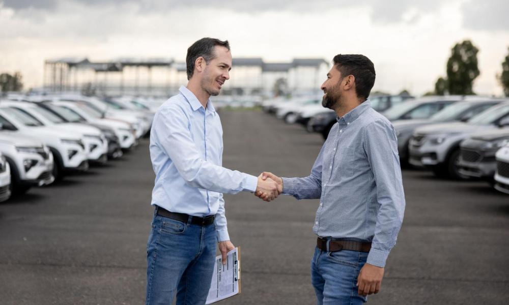 Two men handshaking outdoors