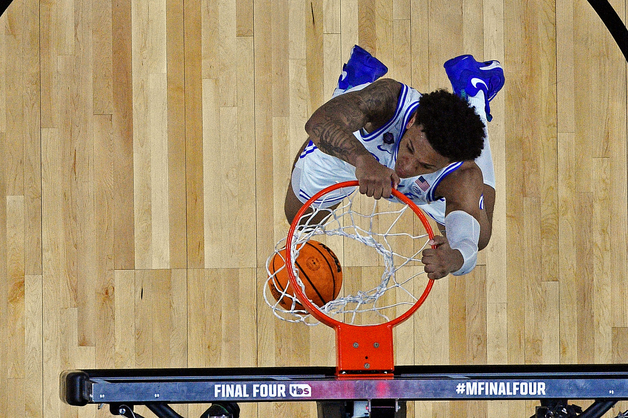 Basketball player dunking in game