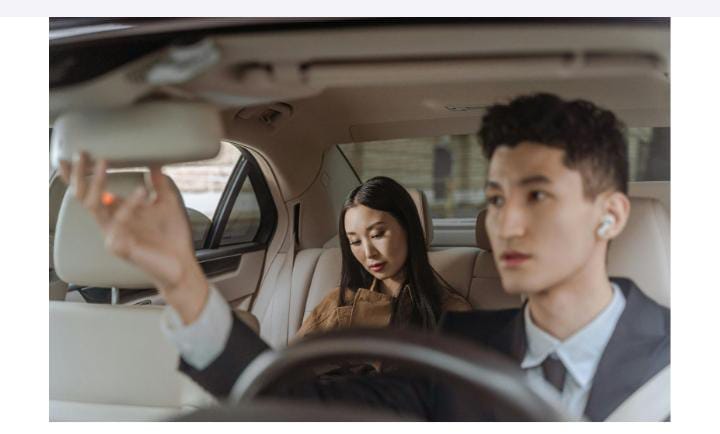 Man driving car with female passenger