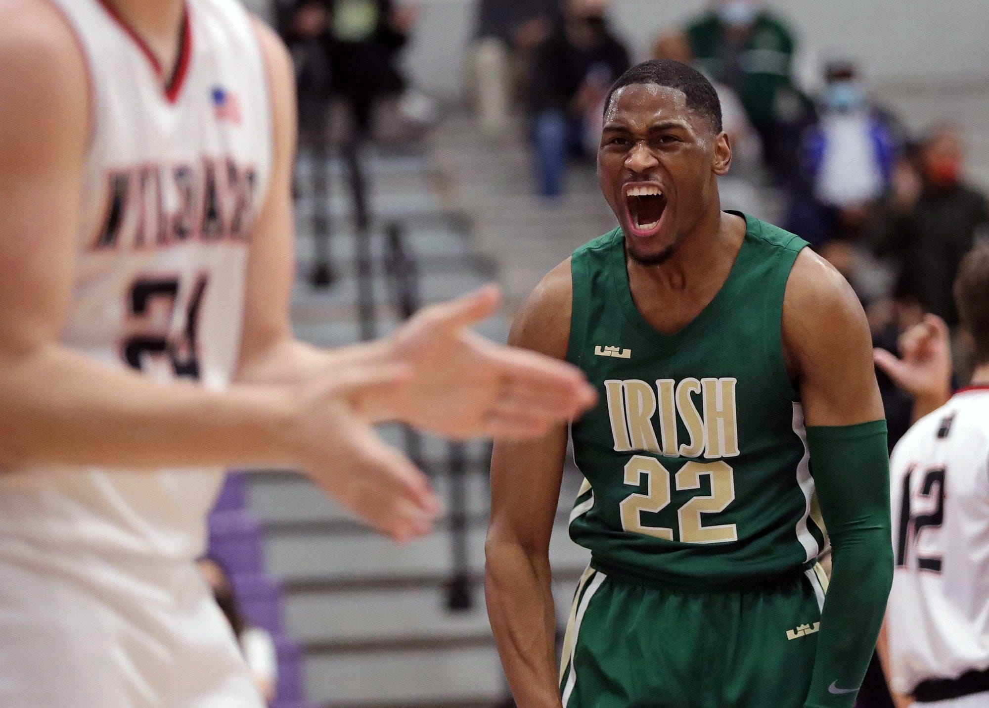 Basketball player in green uniform