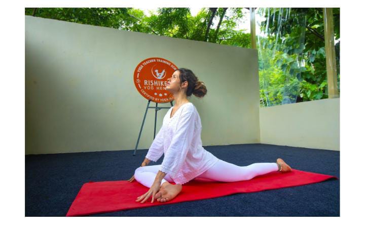 Woman practicing yoga on mat