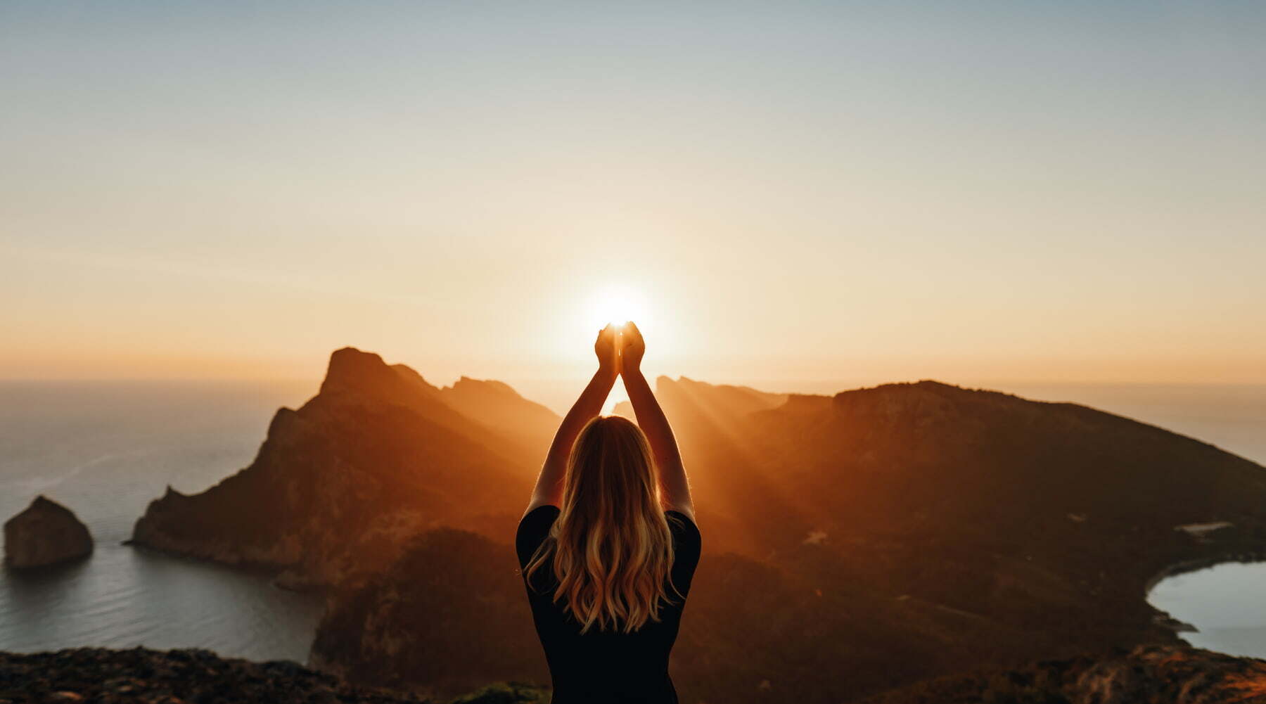 Woman praying with raised hands