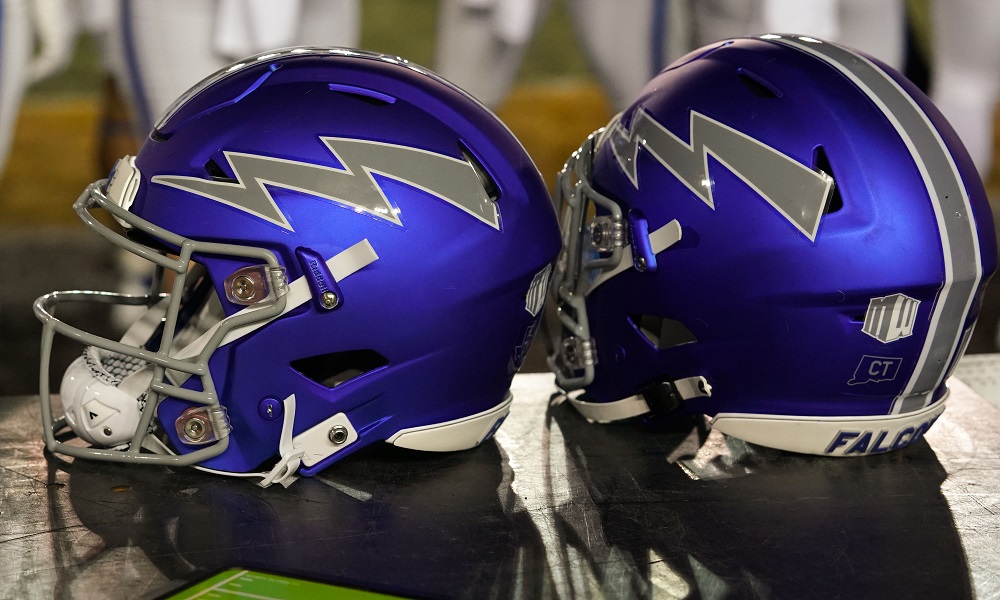 Two purple football helmets facing each other