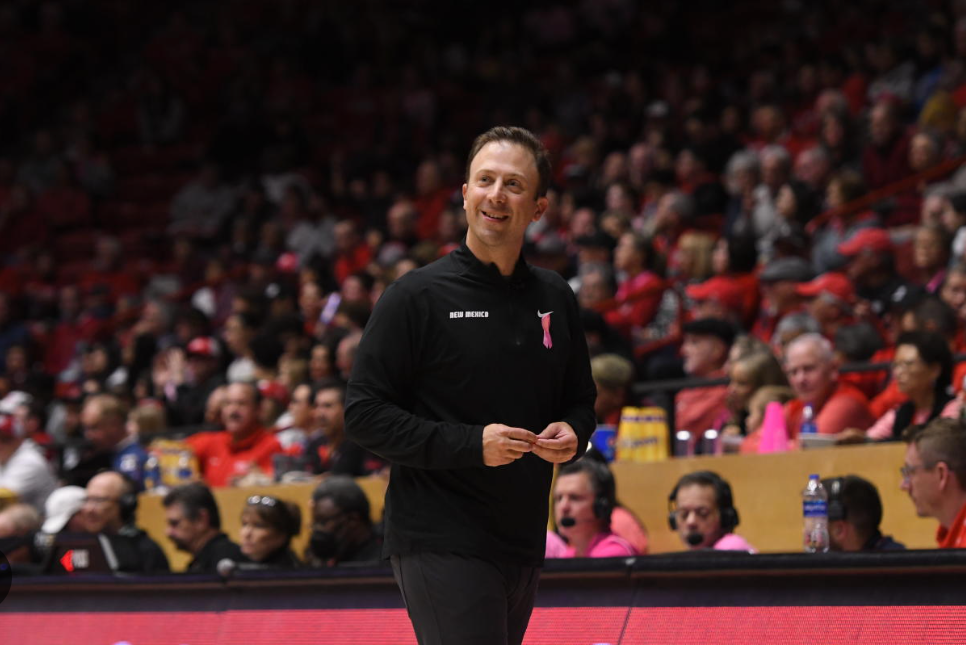 Coach wearing a pink awareness pin