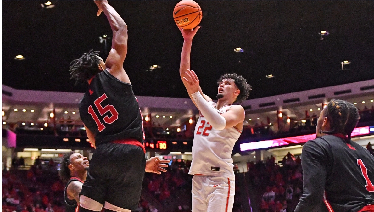 Player shoots basketball at basket