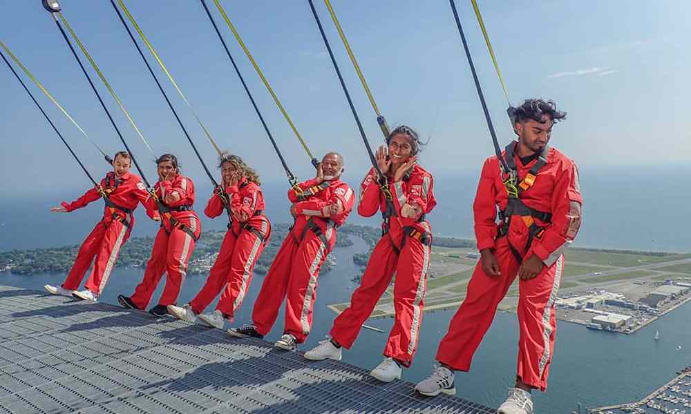 People standing on glass skywalk overlook