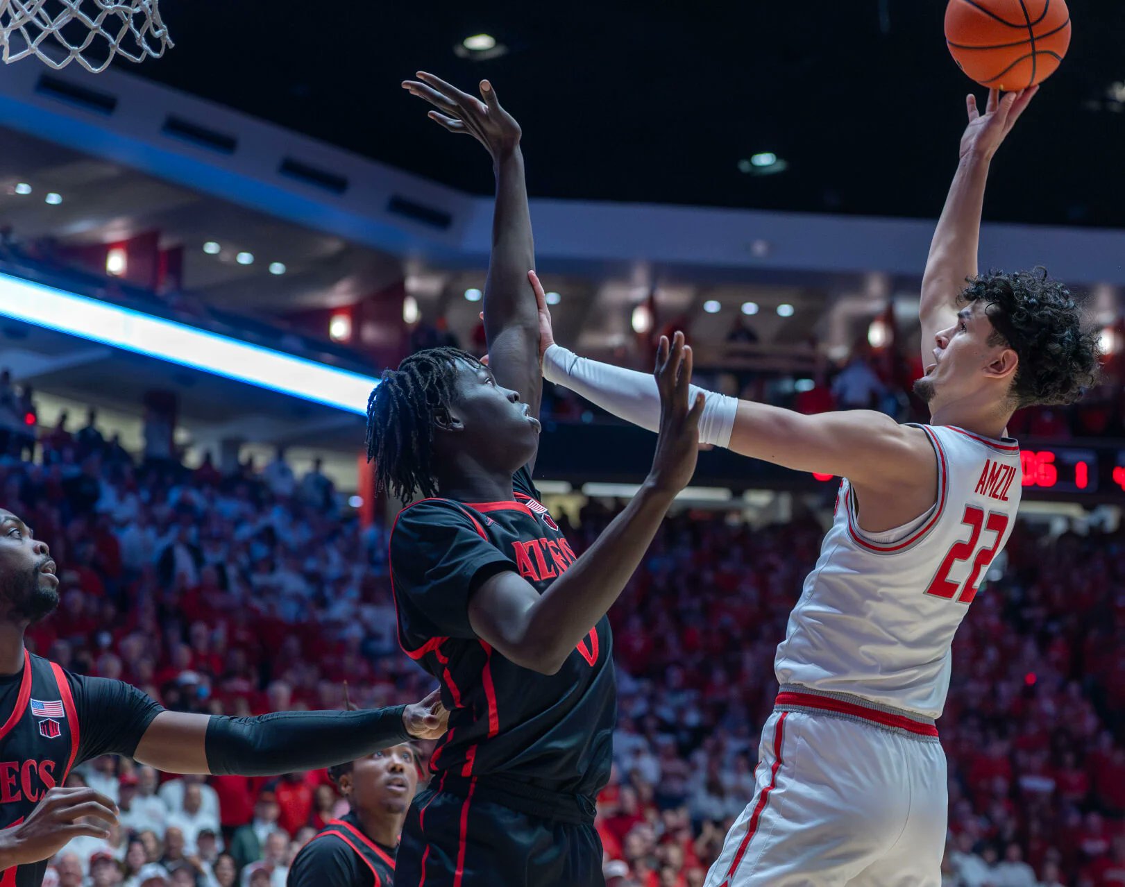 Player shooting basketball at basket