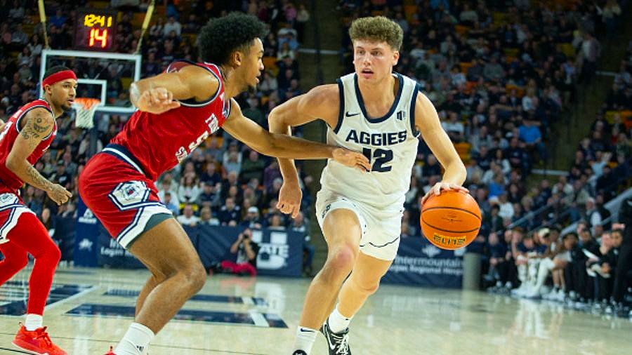 Mason Falslev dribbles for Utah State