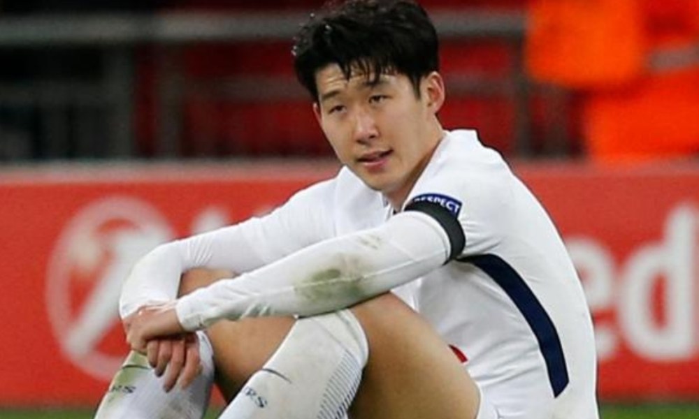 Soccer player sitting in white uniform