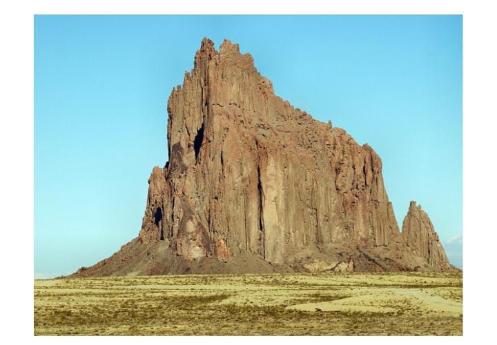 Rock formation in grassy field