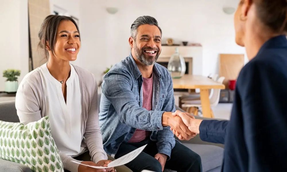 Couple shakes hands with realtor