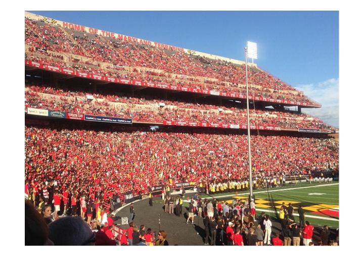 Packed stadium with empty red seats