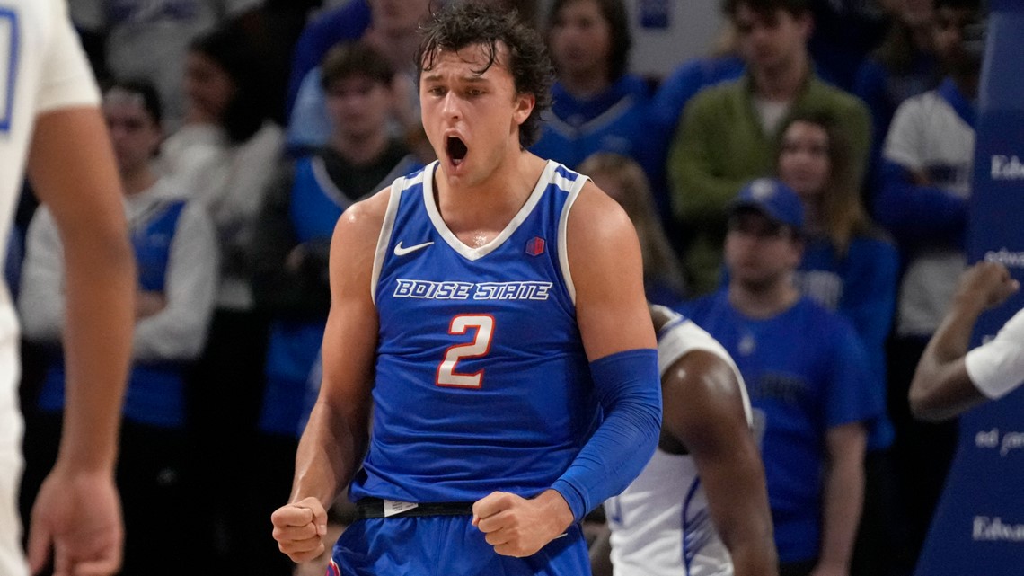 Player shooting basketball in blue uniform