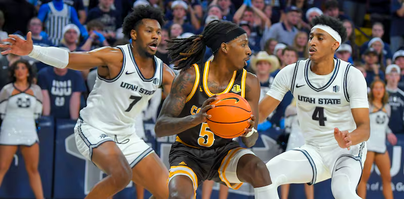 Basketball players competing on court