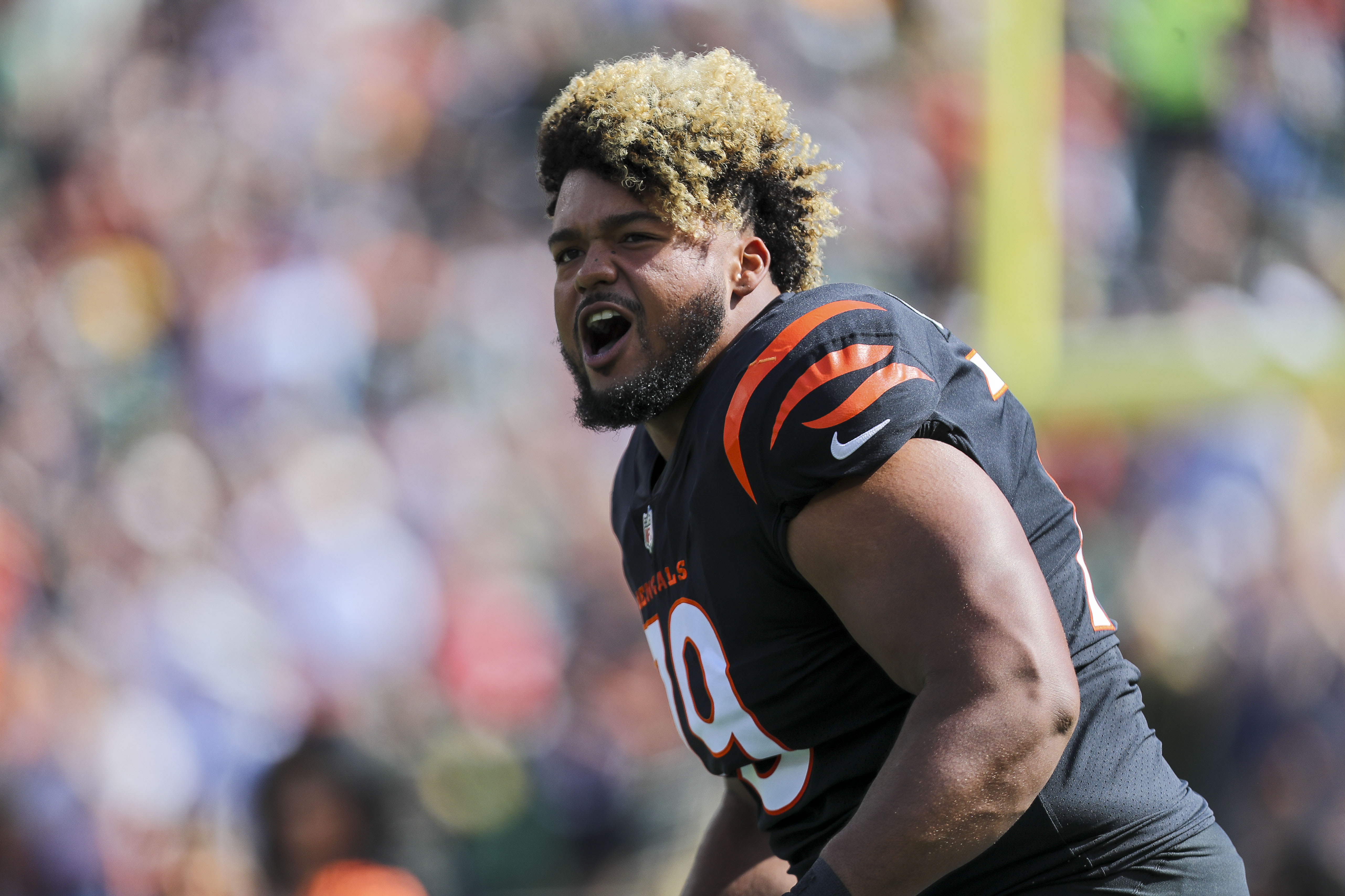 Black-uniformed football player poised midgame